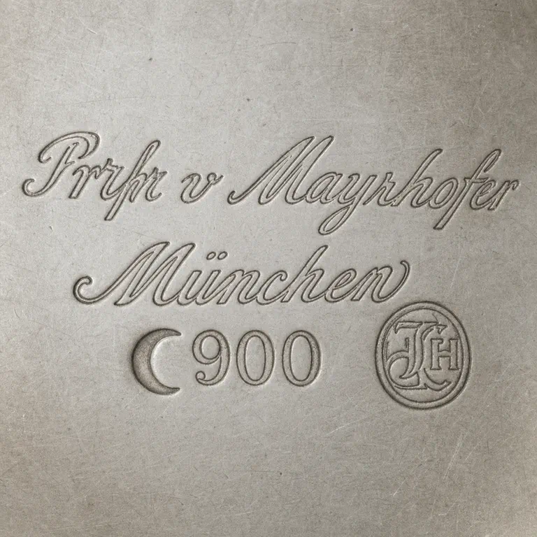 Julius Lemor: Two cursive lines, crescent, 900, and circular monogram without extra glyph; oxidized reconstruction.