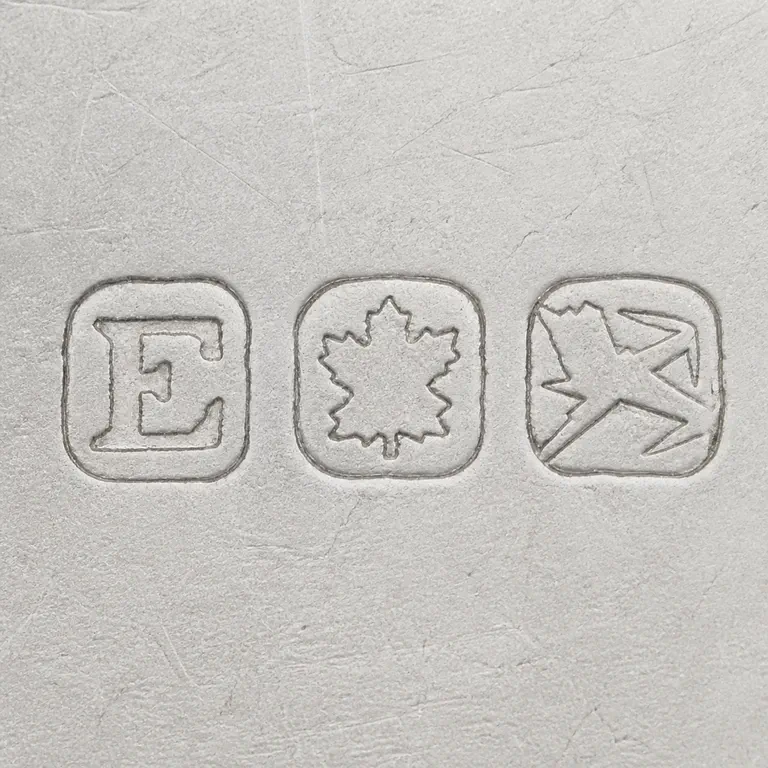 P. W. Ellis & Co.: E, maple leaf; oxidized reconstruction.