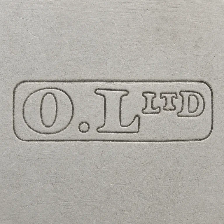Oldfields Ltd.: O.L followed by a smaller raised LTD group, all on one line inside one long narrow rounded-rectangle cartouche; oxidized reconstruction.