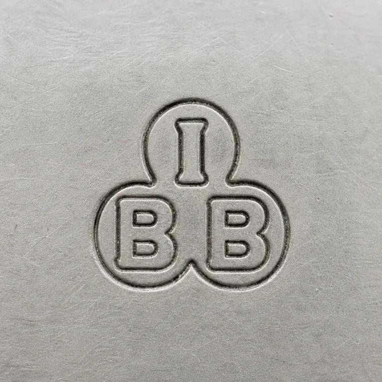 International Bullion & Metal Brokers: A connected clover-like device with an I-like upper form above two B-like lower forms; oxidized reconstruction.