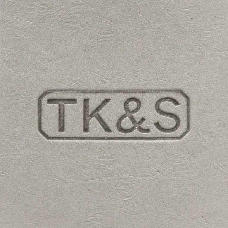 Toye, Kenning & Spencer: T K, ampersand-like separator, and S arranged left to right inside one worn rectangular cartouche; oxidized reconstruction.