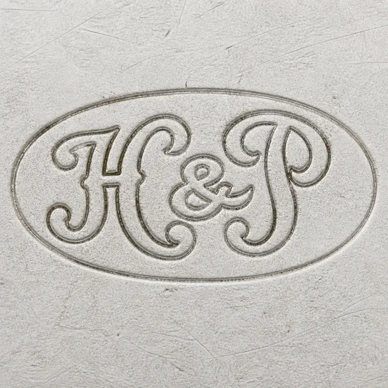 Hicklenton & Phillips Ltd (H G Hicklenton & S A Phillips): Ornate H-like, central separator, and P-like forms with oval enclosure and upright orientation; oxidized reconstruction.