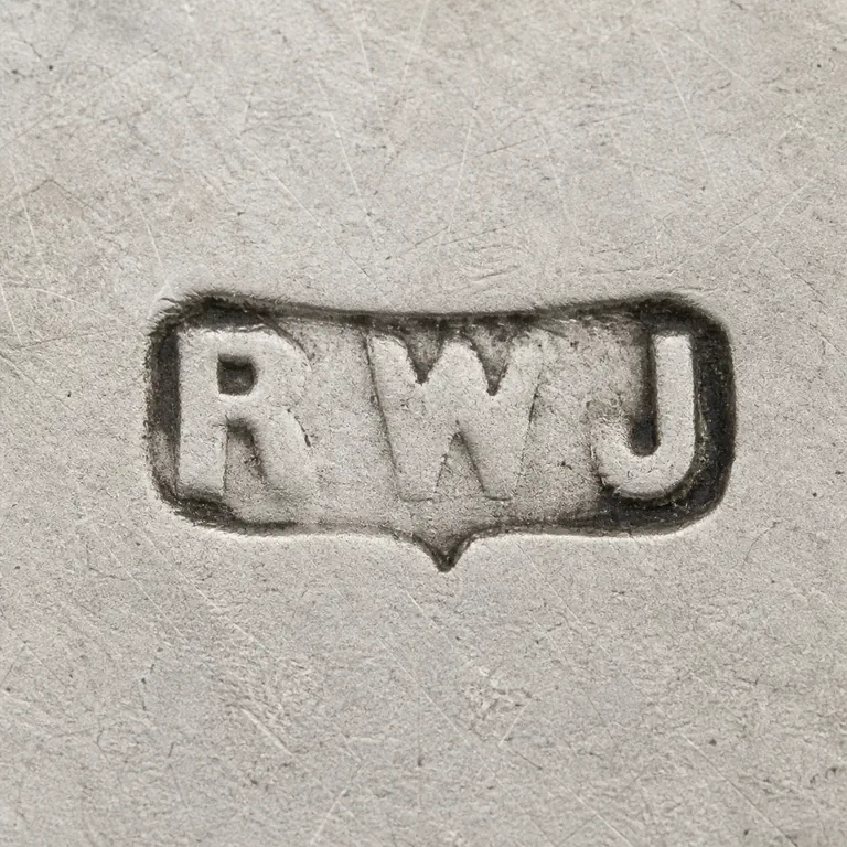 Jay's (Robert William Jay): Visible R W J glyphs in order inside a worn horizontal cartouche with its source-supported lower notch; oxidized reconstruction.