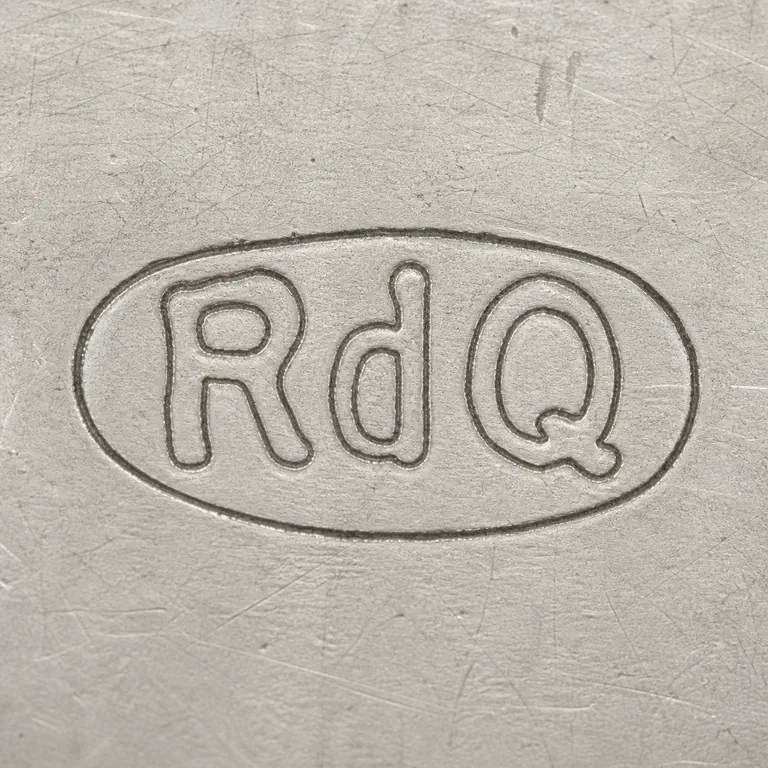 Rebecca de Quin: R, ambiguous d-like middle form, and Q-like final form arranged inside one worn oval cartouche; oxidized reconstruction.