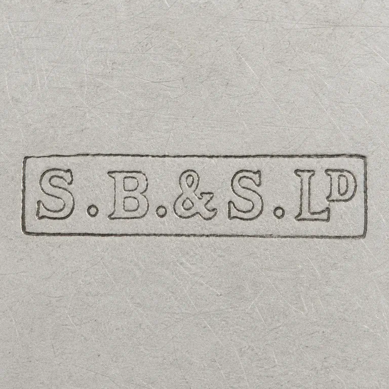 S. Blanckensee & Sons Ltd. Sterling & Crystal Whisky Noggin 1904,…: Uppercase S, one pellet, uppercase B, one pellet, an ampersand, uppercase S, one pellet, uppercase L, and uppercase D inside one long rec…; oxidized reconstruction.
