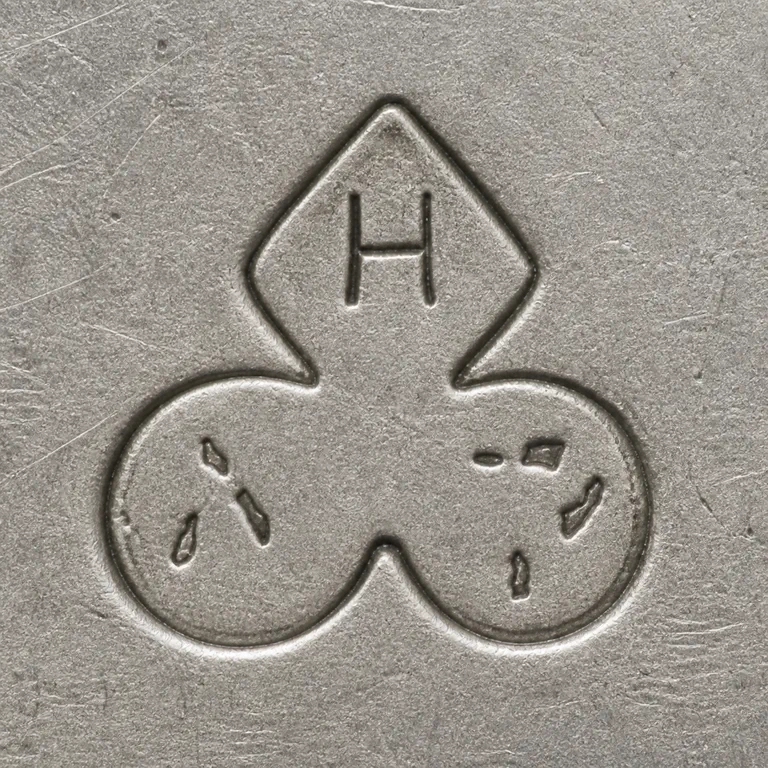 Henry C. Haskell: A connected three-lobed outline with an H-like upper interior and sparse worn fragments in the two lower lobes; oxidized reconstruction.