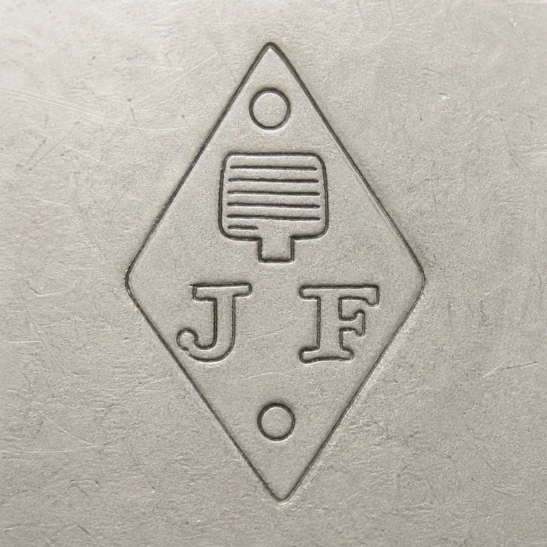 Joseph Antoine: One vertical diamond with J at left, F at right, one small top ring, a striped central rectangular tablet with a short stem, and one smal…; oxidized reconstruction.