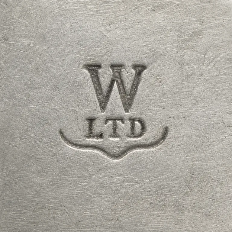 W Ltd: Retry keeps the compact W-over-LTD structure and local lower curved contour without the unsupported broad plaque; oxidized reconstruction.