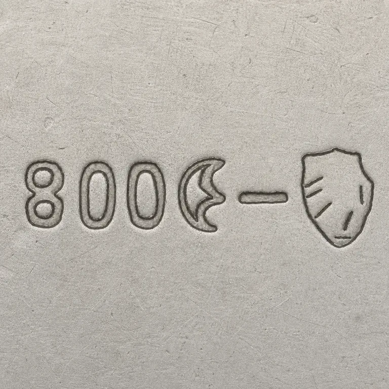 looking for info: Exact 800, crescent, short bar, and one shield terminal with sparse disconnected strokes; oxidized reconstruction.