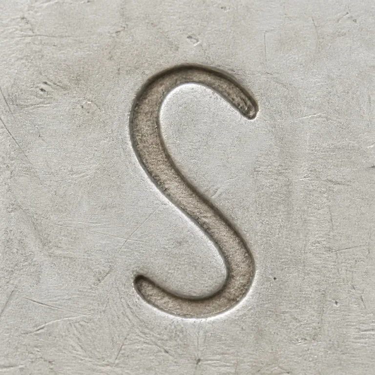 St. Petersburg: One isolated S-like curved glyph with open terminals; oxidized reconstruction.