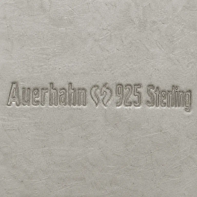 Robert Altermann: The inscription Auerhahn, central paired-lobed maker device, and 925 Sterling in source order; oxidized reconstruction.