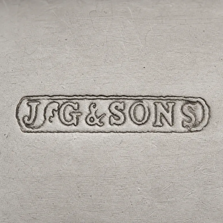 John Grinsell & Sons: Source-bounded low-confidence contour preserves the visible mark geometry and supported lettering or device; oxidized reconstruction.