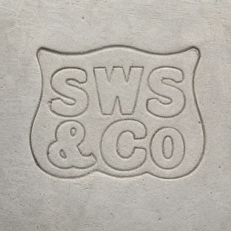 Samuel Walton Smith: Preserves the irregular shield-like outer border, the upper S/W/S-like group, the lower ampersand-like form, C/O-like lower-right group i…; oxidized reconstruction.
