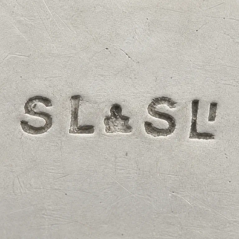 S Lesser & Sons Ltd: Worn horizontal S-L and S-L-like groups with central separator and terminal small detail are reconstructed in source order without a frame; oxidized reconstruction.