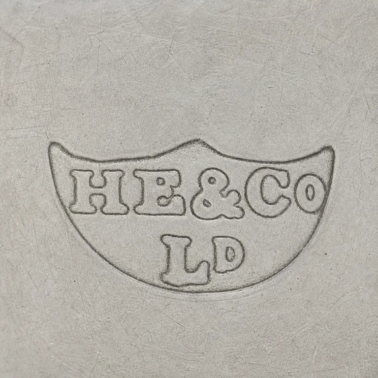 Hawksworth, Eyre & Co Ltd: Fan or shield cartouche with upper HE-like, ampersand-like, and Co-like forms plus lower Ld-like group; oxidized reconstruction.