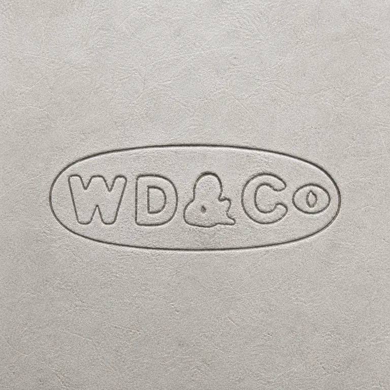 W Dowsett & Co: A rounded plaque with W and D groups, a central ampersand-like form, and a Co-like right group is reconstructed; oxidized reconstruction.
