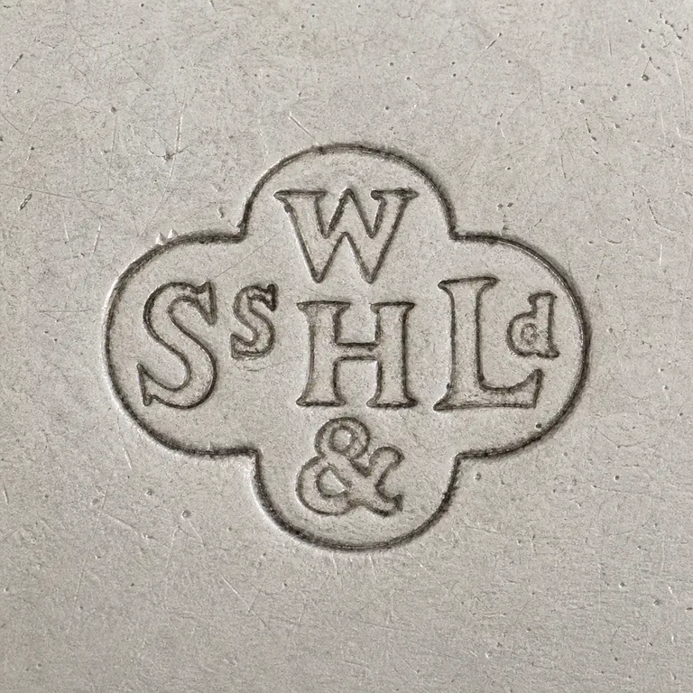 William Hutton & Sons: Uppercase W in the top lobe; uppercase S followed by one small raised s in the left lobe; uppercase H in the center; uppercase L followed…; oxidized reconstruction.