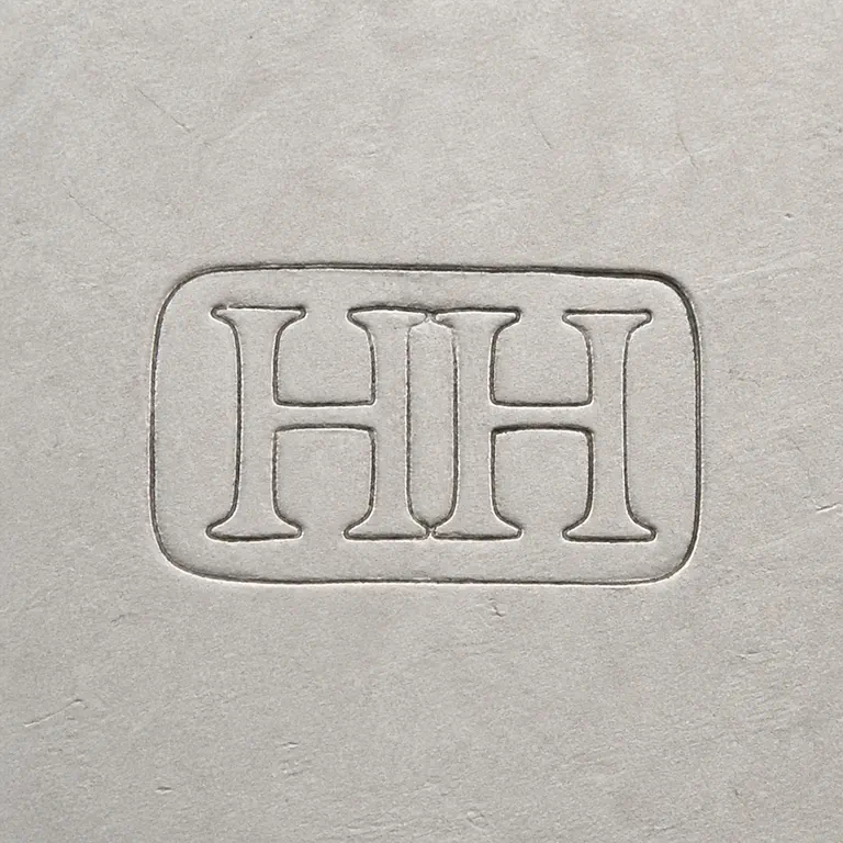 Harrison Bros. & Howson: Two worn uppercase H letters with closely overlapping central vertical strokes, inside one horizontal rounded-rectangle cartouche; oxidized reconstruction.