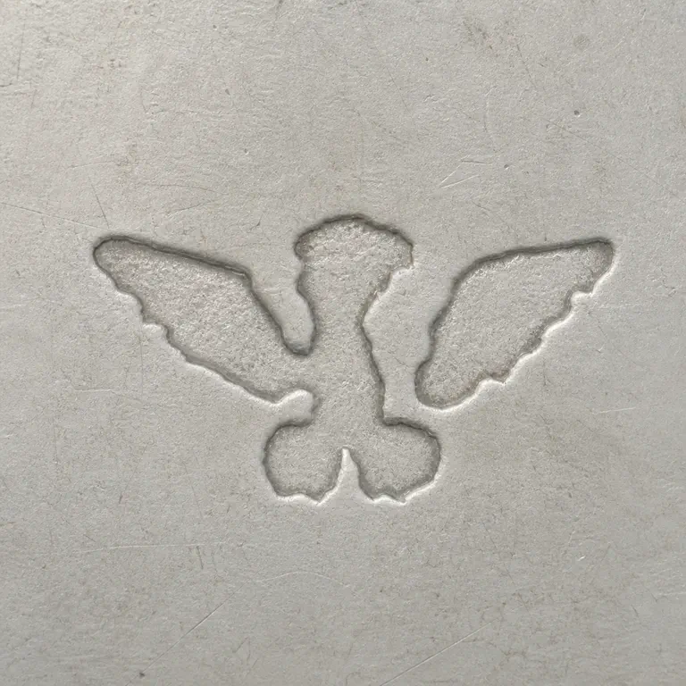 The Merrill Shops: Sparse unresolved three-lobed winglike silhouette; oxidized reconstruction.