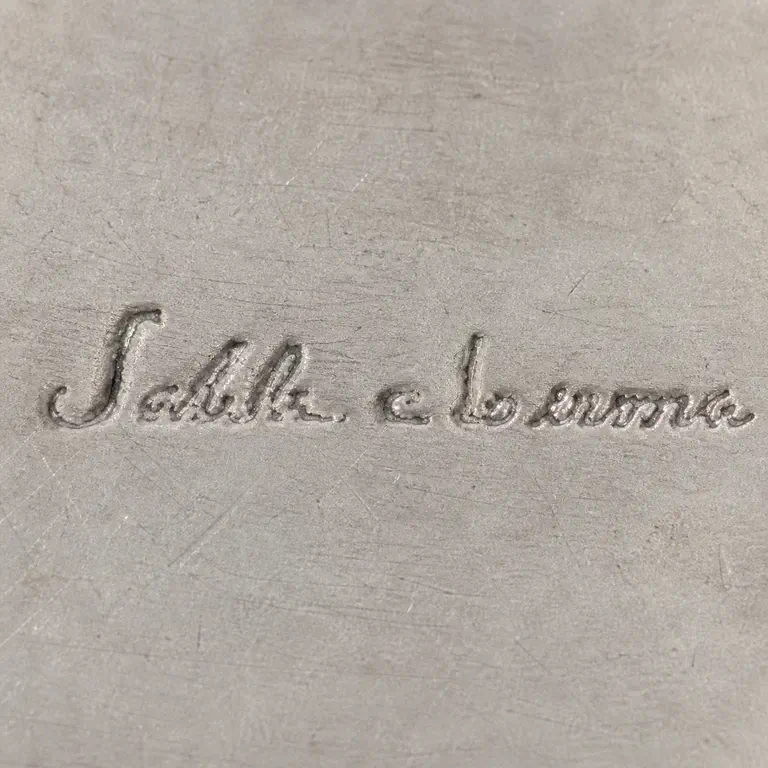 Salvador De La Serna: One isolated low-contrast cursive maker line has a tall initial stroke, connected left word, a short de-like middle group, and a connecte…; oxidized reconstruction.