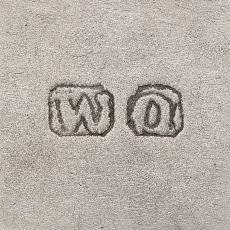 William Owen: Two separate rounded punches left to right as W-like and O-like forms; oxidized reconstruction.