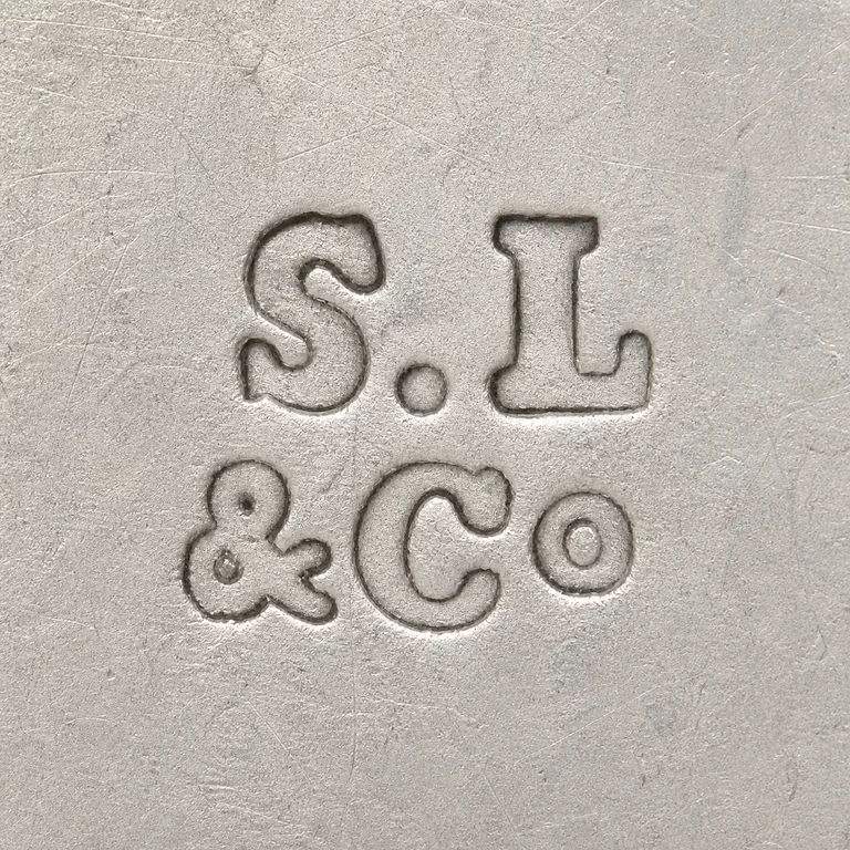 S Lynnie & Co: Two-row arrangement. upper S.period.L and lower ampersand/C/O grouping, with no enclosing border added; oxidized reconstruction.