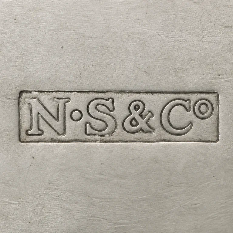 Nathaniel Smith & Co.: N·S&Co as uppercase N and S separated by one centered dot, followed by an ampersand, uppercase C and small lowercase o, all on one line i…; oxidized reconstruction.
