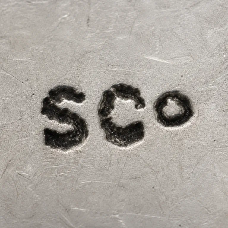 S Co: Final render preserves exactly three separate dark forms in order: S-like, C-like, and a small O-like rounded form, with no intermediate…; oxidized reconstruction.