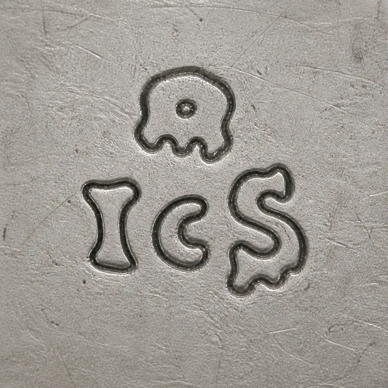 I S: Unfilled contour reconstruction of the compact multi-part mark: upper irregular device with central opening and lower separated I/C/S-lik…; oxidized reconstruction.