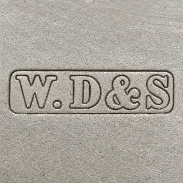 W M Dowler & Sons: Outlined reconstruction of the long rectangular plaque with W, separator dot, D, ampersand-like, and S forms in order; oxidized reconstruction.