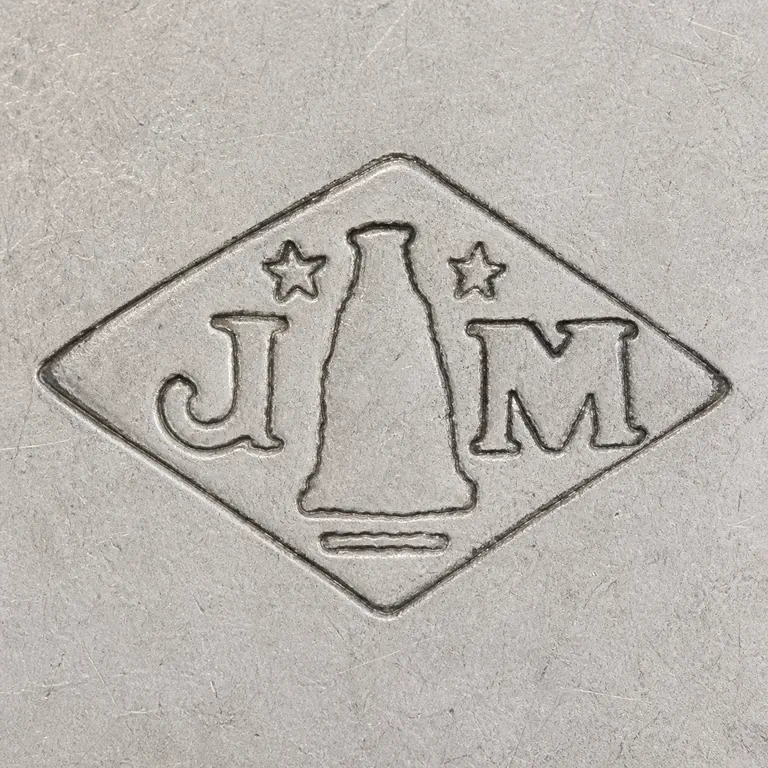Joseph Antoine: Horizontal diamond with J left, M right, two five-point upper stars, one tapered central silhouette, and one lower bar; oxidized reconstruction.