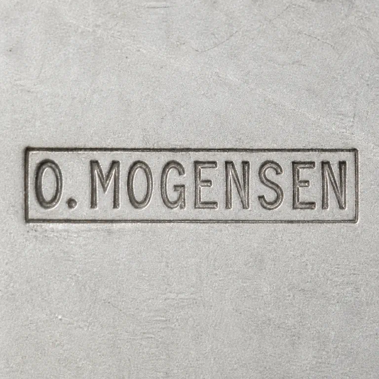 O.A.: Reconstruction preserves uppercase O.MOGENSEN, one period after O, and one rectangular cartouche; oxidized reconstruction.
