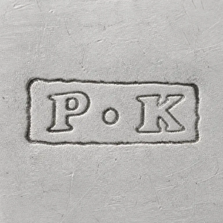 Peter Kempson Jnr.: P-like and K-like forms left to right with one central dot-like separator inside a worn rectangular cartouche; oxidized reconstruction.