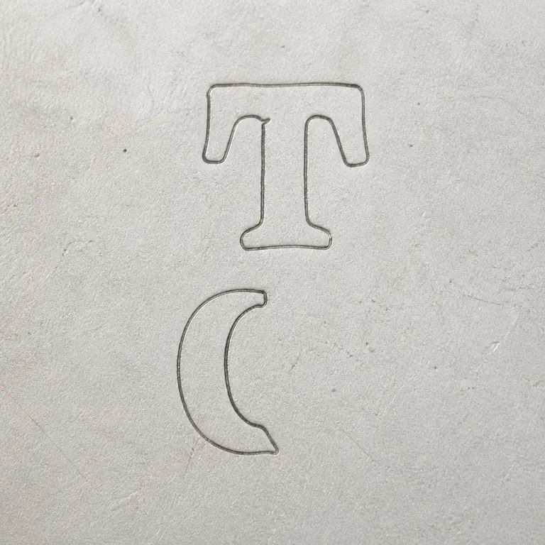 Theodore C Clark: The clearly supported upper T and lower rounded C-like/open form remain in the original vertical arrangement. The unsupported broad outer…; oxidized reconstruction.