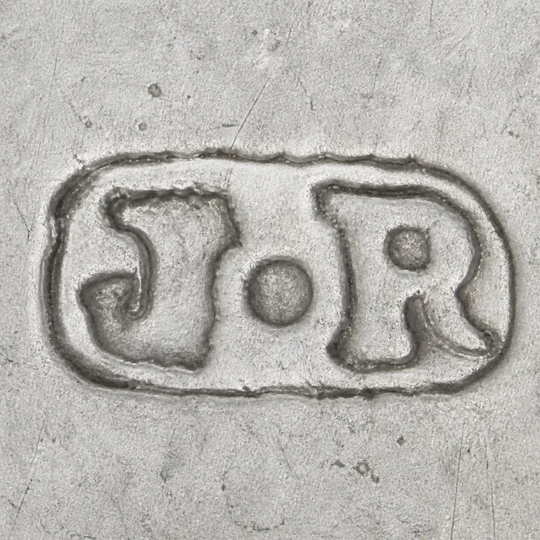 James Rooker: Conservative J-like left form, central separator, R-like right form, and single rough oval enclosure in source orientation; oxidized reconstruction.