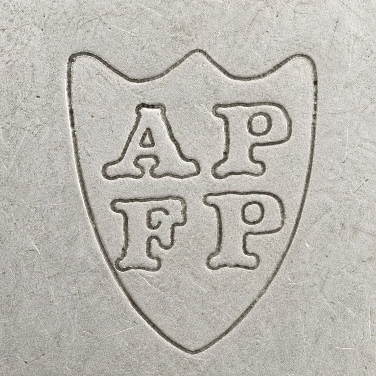 Vander & Hedges Tessiers Ltd (after 1920): Shield silhouette and stacked upper/lower two-form arrangement. including the A/P-like and lower paired forms; oxidized reconstruction.