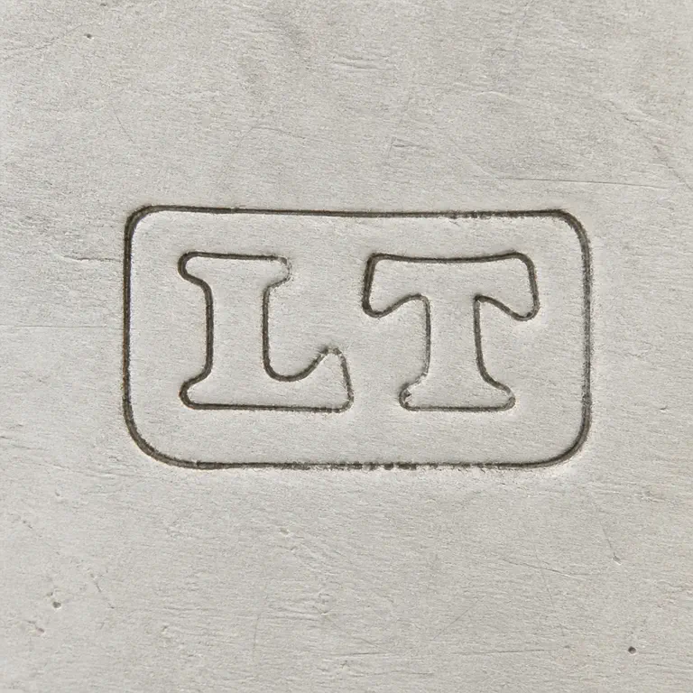 L T: A rounded rectangular punch with supported L and T forms is reconstructed border and horizontal orientation; oxidized reconstruction.