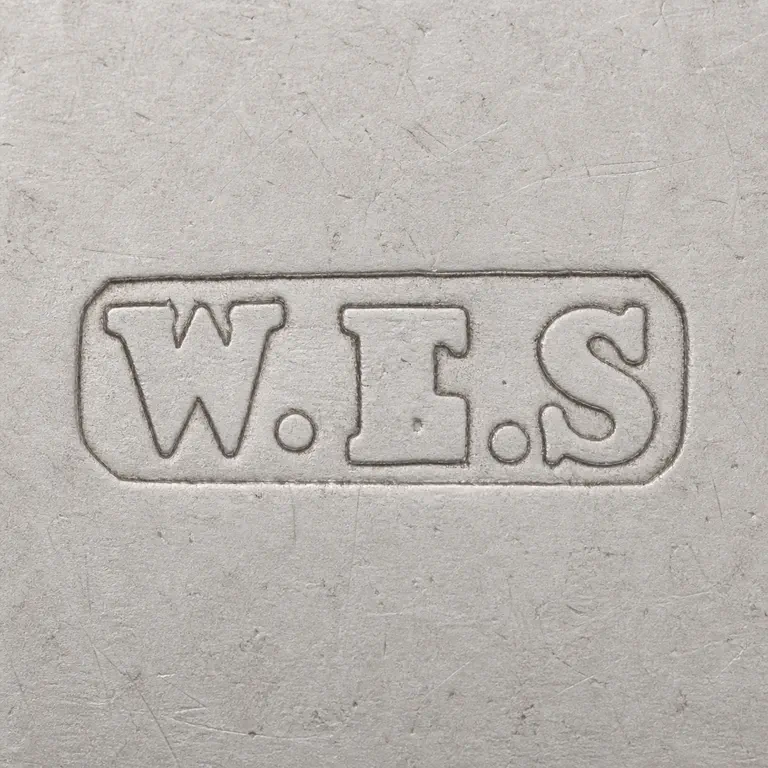 William Ernest Stallard: A rectangular W.E.S punch with two punctuation marks is reconstructed with border, spacing, and symbol order; oxidized reconstruction.