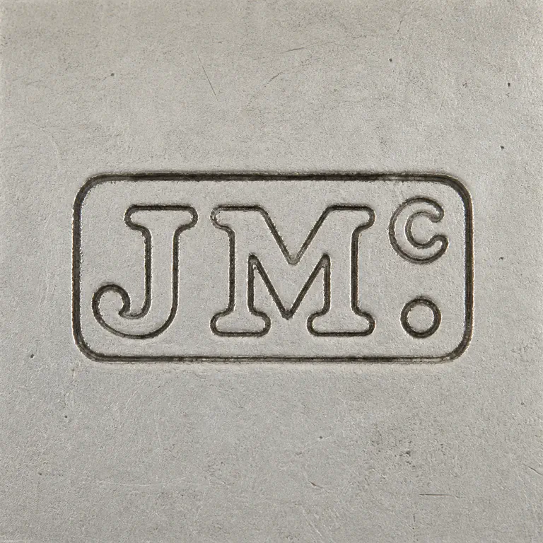 James McKay: J/M-like grouping with raised C-like detail and terminal dot-like detail is reconstructed inside the local rounded rectangular boundary i…; oxidized reconstruction.