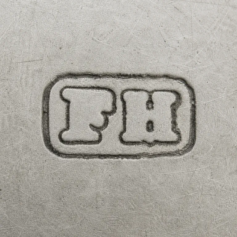 Hewson & Williams (Frederick Hewson): Paired F and H-like forms arranged left to right inside one worn rectangular cartouche; ambiguous internal H strokes retained conservatively; oxidized reconstruction.