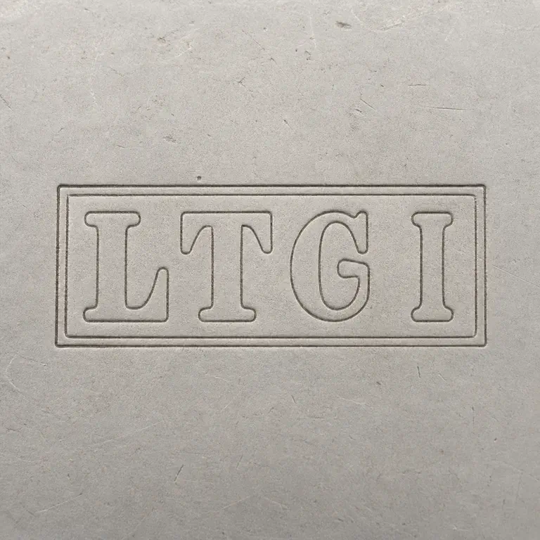 L T G Ltd (or L: Preserves the double rectangular border, L/T/G-like sequence, final tall form, spacing, and left-to-right orientation; oxidized reconstruction.