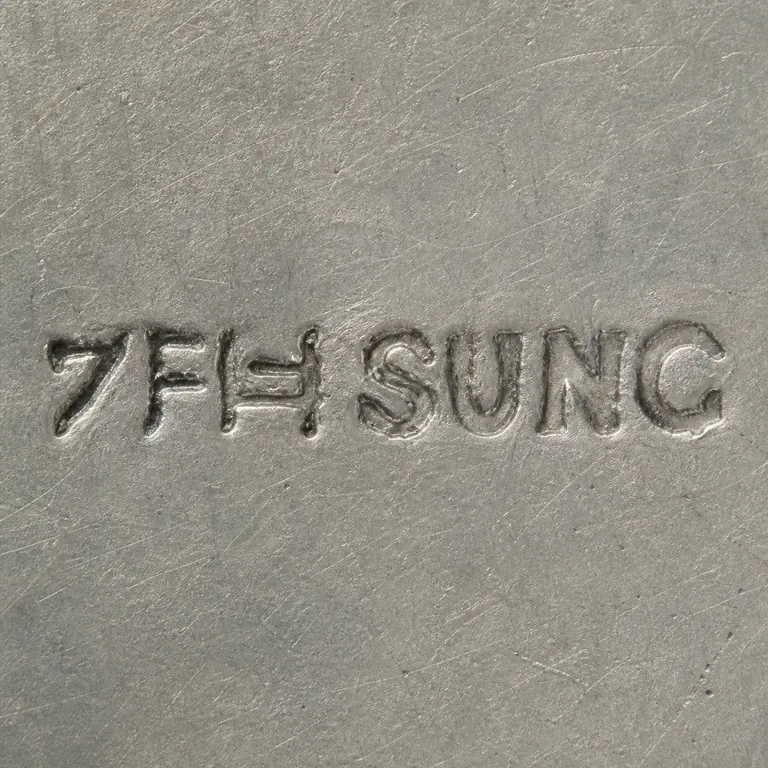 SILVERSMITH: Two source-ordered logographic-like contour groups precede exact uppercase SUNG without an enclosing border; oxidized reconstruction.