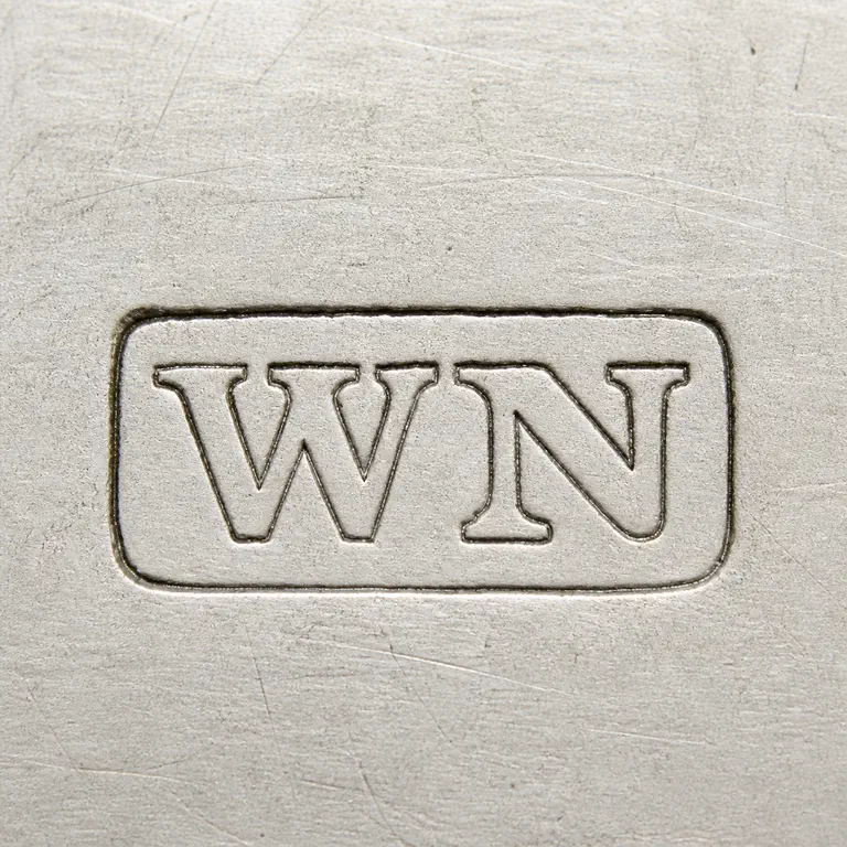 William Needham: Uppercase W followed by uppercase N without punctuation on one line inside one compact horizontal rectangular cartouche; oxidized reconstruction.