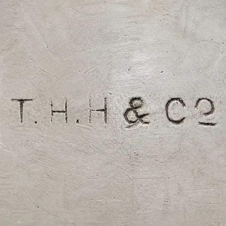 T H Hazlewood & Co: T-like, H-like, H-like, ampersand-like, C-like, and terminal partial form retained in order; oxidized reconstruction.