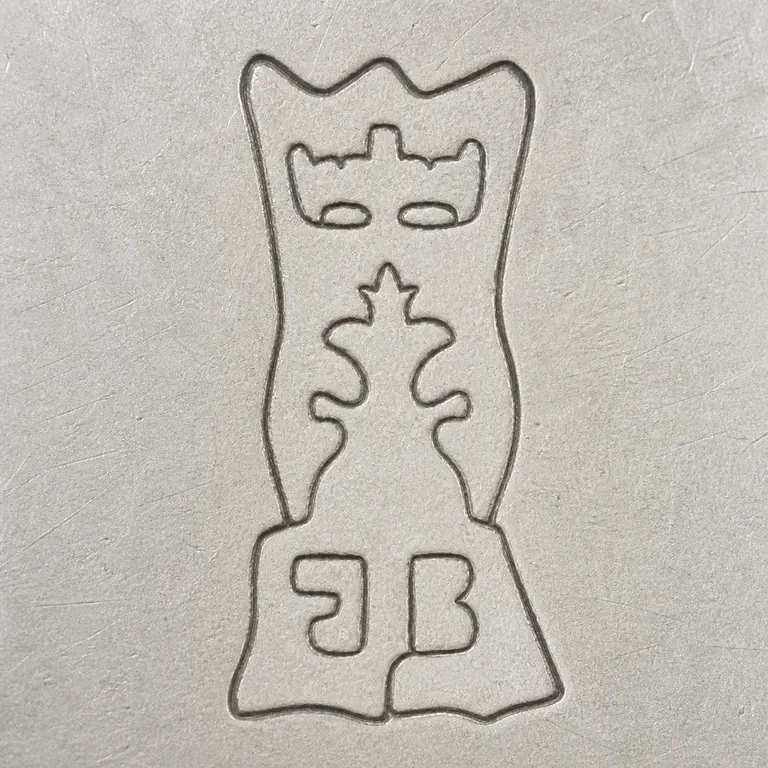 Joseph Barbut: A tall shield/crest outline with sparse internal ornament and two lower J/B-like central forms is reconstructed in unfilled contour lines; oxidized reconstruction.