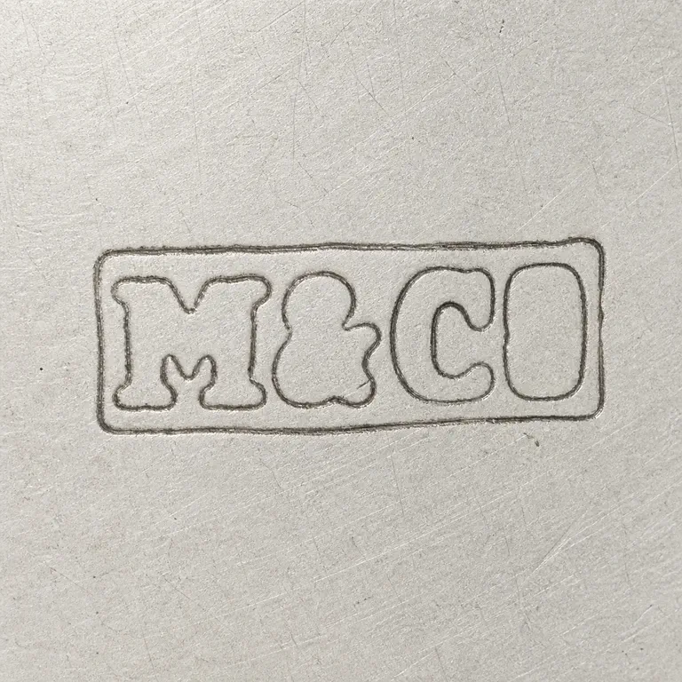 Robert Mitchell & Co: M, ampersand-like separator, and C O arranged left to right inside one worn rectangular cartouche; oxidized reconstruction.