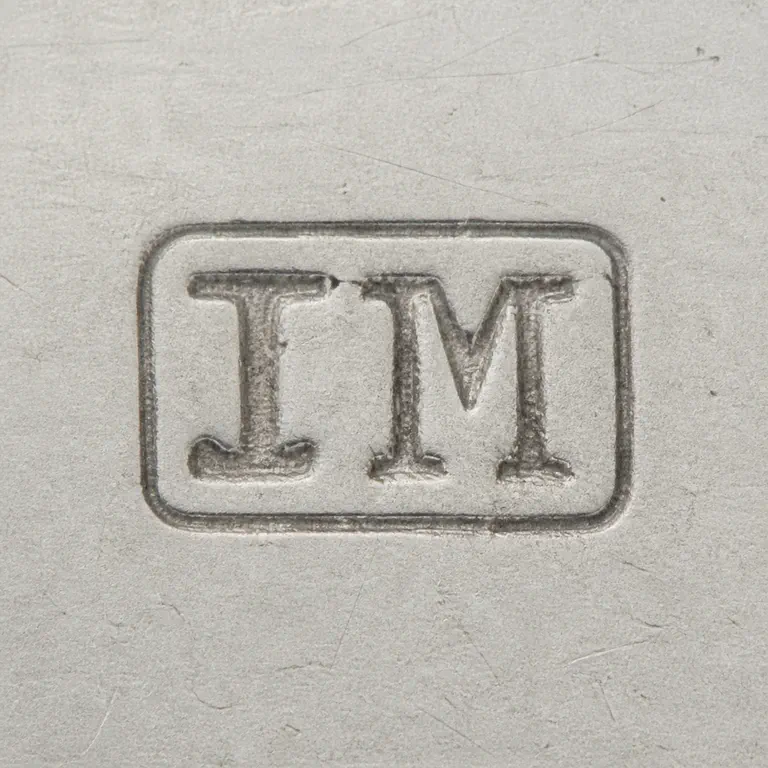 Jonathan Mappin: JM as two uppercase serif capitals without punctuation, centered inside one compact horizontal rectangular cartouche; oxidized reconstruction.