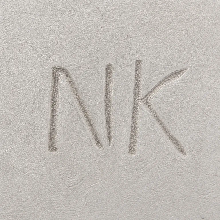 SILVERSMITH: Large narrow uppercase N K in source order dark photographed crop removed and no invented enclosure; oxidized reconstruction.