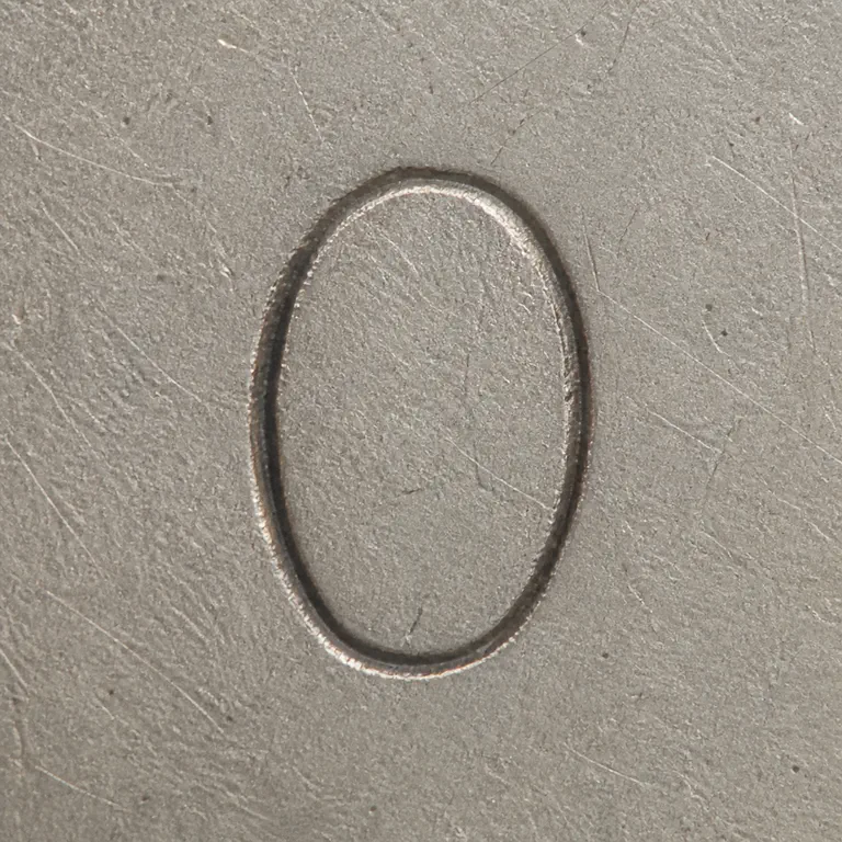 St. Petersburg: One isolated irregular oval O-like glyph with an open interior; oxidized reconstruction.