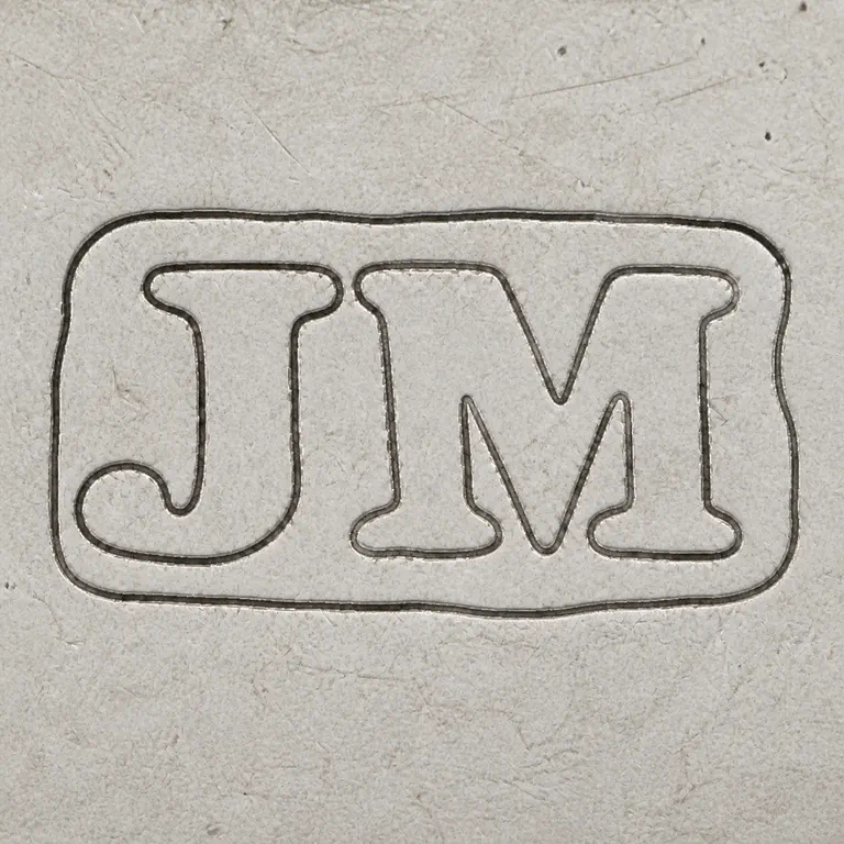 J M: J-like and M-like pair retained inside the compact irregular rectangular border; oxidized reconstruction.